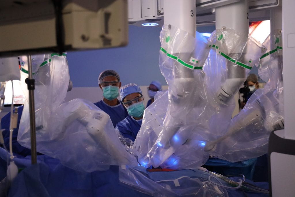 Urology team in operating room with surgical robot